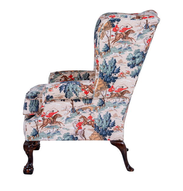 side of wingchair with trees and horses on fabric