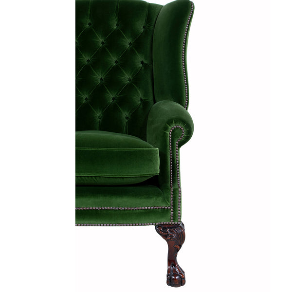 buttoned back green velvet wingchair arm and leg 
