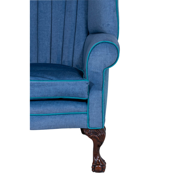 arm and mahogany leg of a blue wingbacked chair from brights of nettlebed