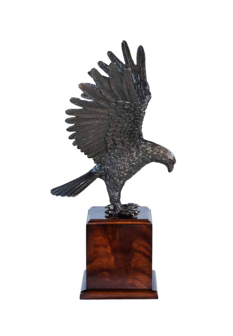 Bronze sculpture of an eagle on a wooden base against a white background