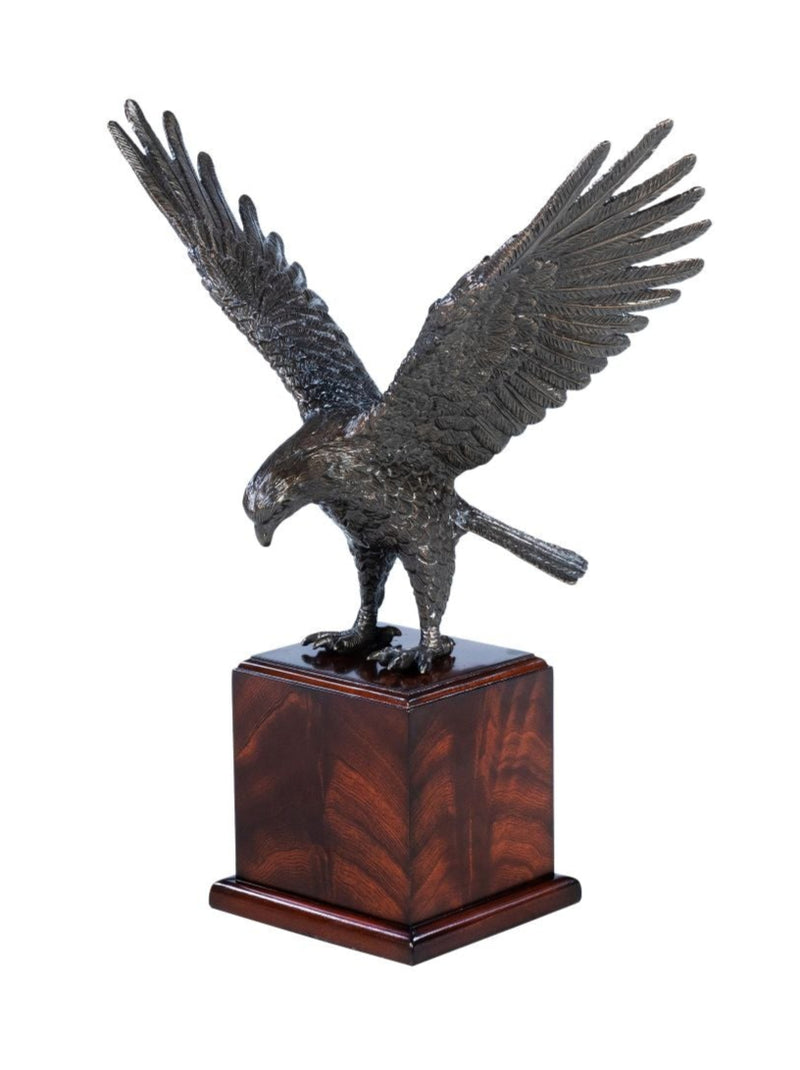 Bronze sculpture of an eagle on a wooden base against a white background