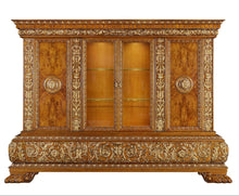 Decorative wooden cabinet with gold embellishments on a white background
